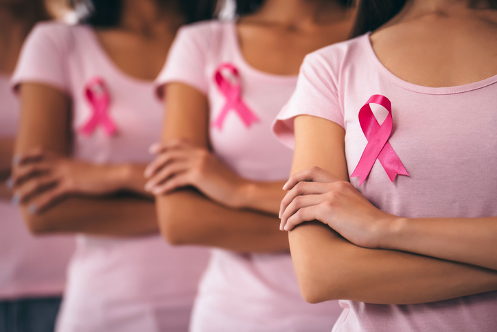 Women with pink ribbons representing breast cancer