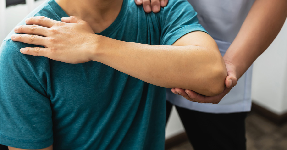 Patient receiving physical therapy for injured arm.