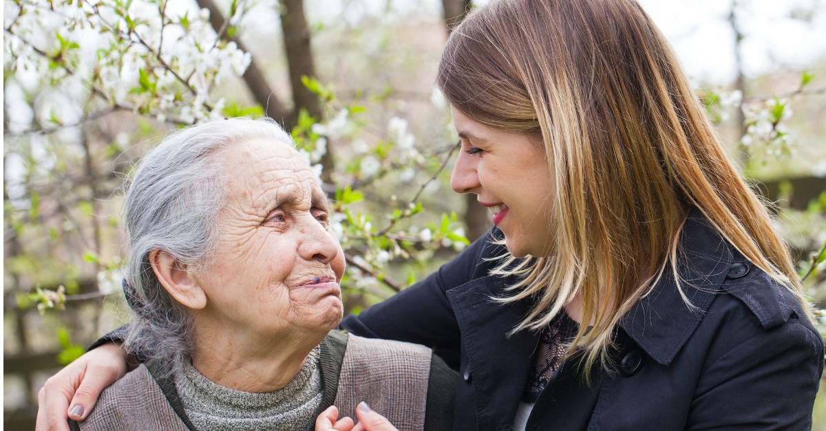 Elderly Woman with Cheerful Caregiver-