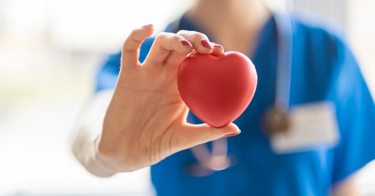 female provider holding heart symbol of life