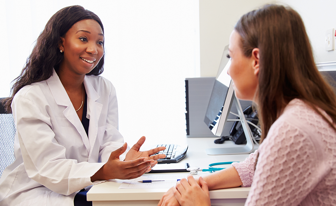 A caring doctor helping patient understand her breast cancer diagnosis.