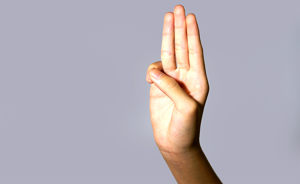 A hand displaying the Girl Scouts honor code.