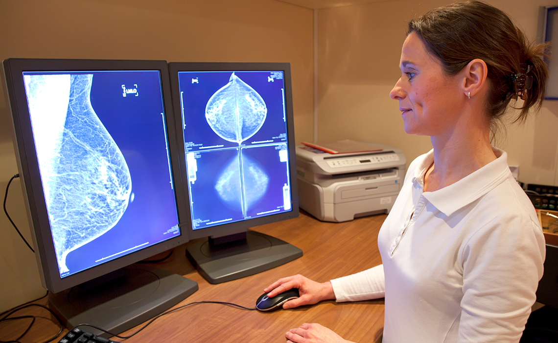 A radiologist reading a patient’s mammography results.